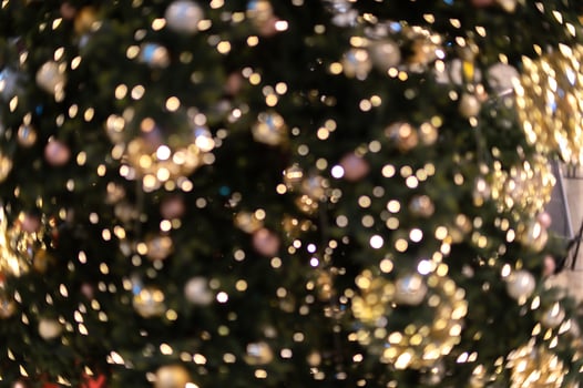Gold Christmas background of de-focused lights with decorated tree. decorated Christmas tree with golden toys photo