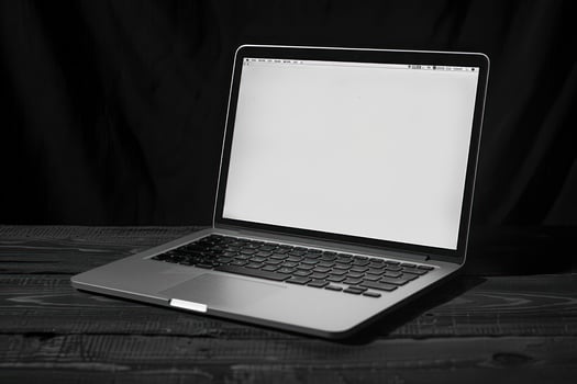 Sleek laptop on dark wood surface photo