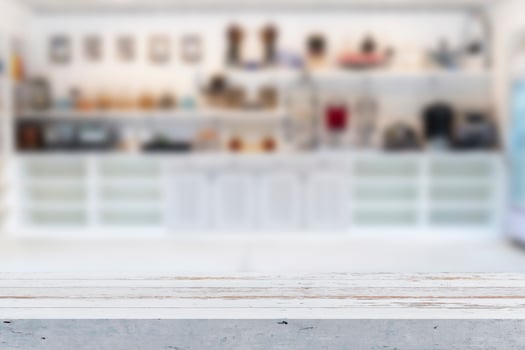 Wooden table on blurred background of kitchen window and shelves. photo