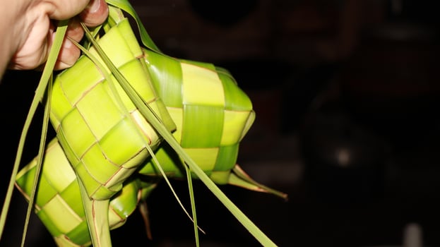 Ketupat is a food made from rice which is wrapped in woven young coconut leaves photo