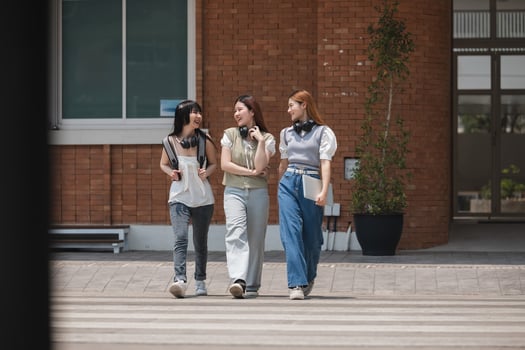 Group of happy students walking along the corridor at college photo