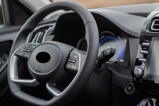 Interior of the car interior. Steering wheel, instrument panel, computer screen, automatic transmission photo