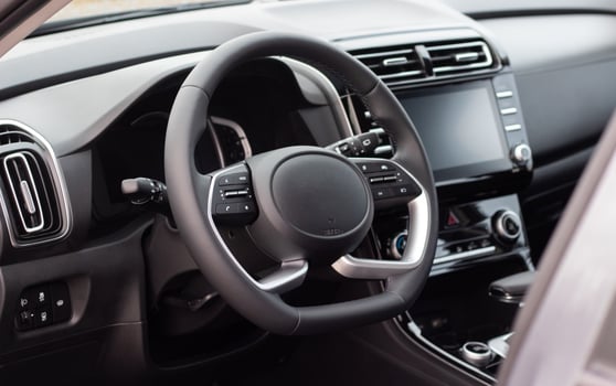 Interior of the car interior. Steering wheel, instrument panel, computer screen, automatic transmission photo