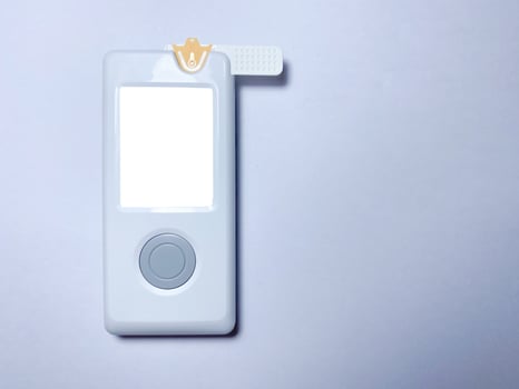 Measurement of blood sugar levels using a glucose meter with a mock-up. Piercing a finger to draw blood photo