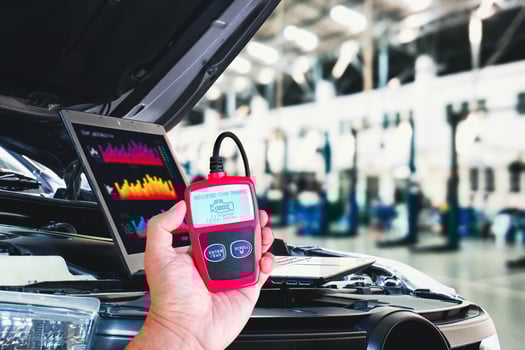 OBD2 or OBD scanner tool and laptop for engine system analysis to fixing car engine system in the auto repair shop , Car maintenance service concept photo