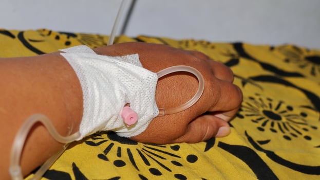 person's hand being given an IV photo