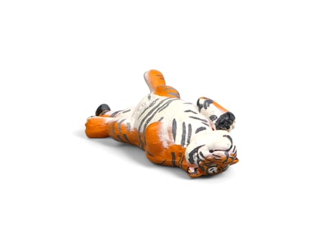 Decorated miniature tiger animal lying down isolated on white photo