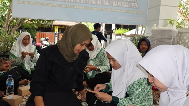 Women knitting wool yarn together photo