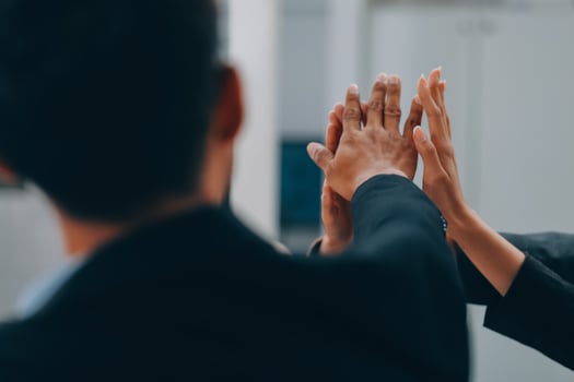 Motivated successful business team giving high five, happy young students employees group join hands with senior teacher mentor, team building unity concept, help support in teamwork, close up view photo