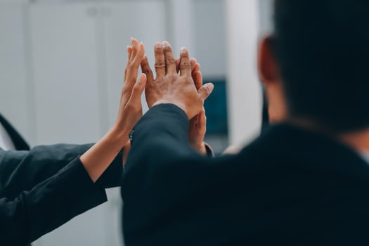 Motivated successful business team giving high five, happy young students employees group join hands with senior teacher mentor, team building unity concept, help support in teamwork, close up view photo