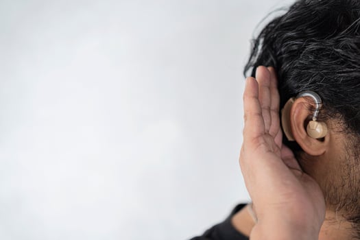 A man in his late 40s began to have difficulty hearing and had to use a hearing aid. photo