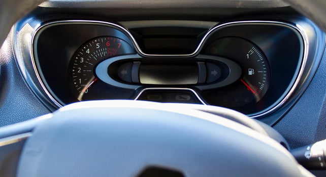The dashboard in the car interior. The rpm and the amount of fuel in the tank photo