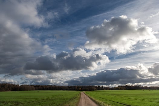 Dramatic sky with dark rain clouds over of autumnal country landscape photo