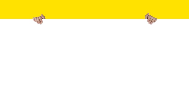 Woman's hand holding a blank banner raised to cover the model on a yellow background. photo