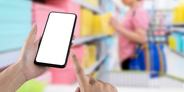 Mockup blank white screen mobile phone with finger point and touch on touchsreen with women are shopping in department stores. photo