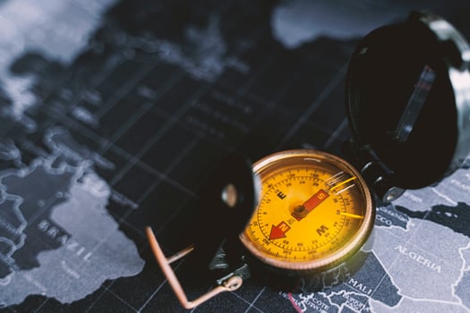 Vintage world map with compass. Compass on map. Tourist compass for orientation on the terrain. photo