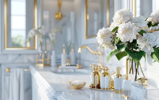 Elegant bathroom with luxurious gold accents, white marble countertops, and fresh floral decorations in a bright, natural light setting. photo
