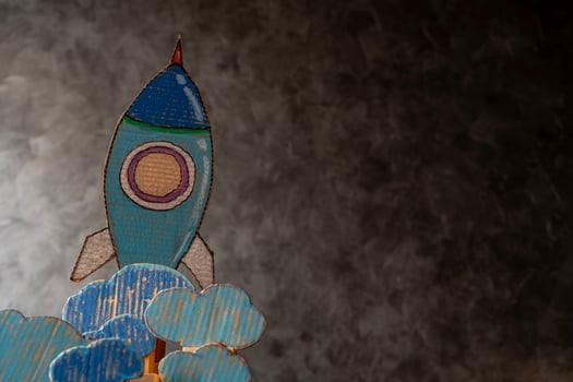 Education and back to school concept. Paper rocket on the blackboard background in the classroom photo