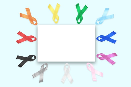 Colorful awareness ribbons with place for text on blue background. World cancer day concept, February 4. Healthcare and medicine photo