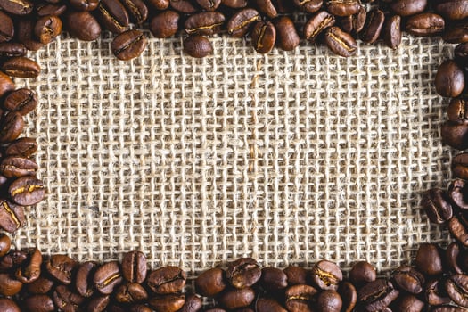 A frame of Coffee beans, on Burlap fabric. Background voor coffee related products. photo