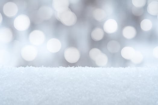 Winter background with snow drifts and holiday lights in bokeh photo