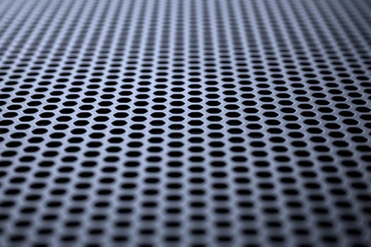 Metallic surface with regular round holes. Industrial background photo