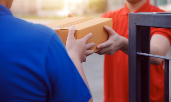 Asian delivery express courier young man use giving boxes to woman customer he wearing protective face mask at front home photo
