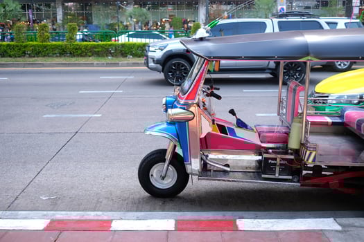 Blue red thailand tuk tuk tricycle in side view photo