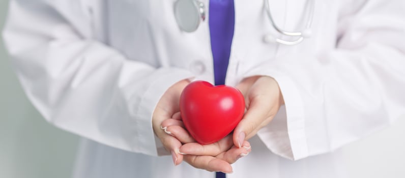 Doctor hand holding red heart shape in hospital. love, donor, world heart day, world health day, CSR donation and Insurance concepts photo