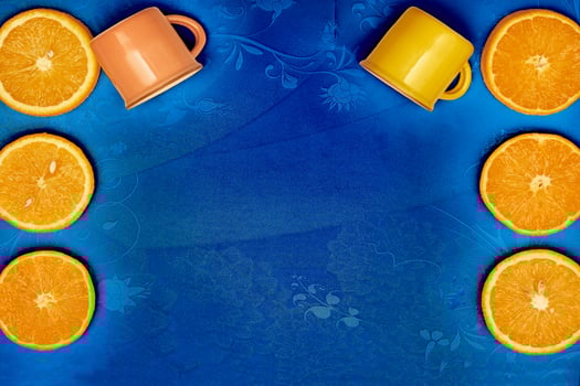Juicy oranges, two cups on blue tablecloth.Ready to eat,drink and cook photo