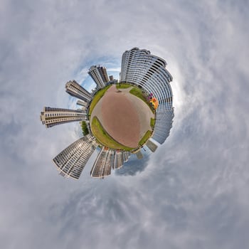 abstract swirling tiny planet spherical panorama of multi-storey buildings of skyscrapers of a residential complex in the form of a butterfly, bugs, crabs in sky with clouds photo