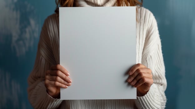 Woman in cozy white sweater holding blank piece of paper mockup. Winter theme. Empty a4 pamphlet template advertising image. Minimalist design. Blank sheet mock up product photorealistic photo