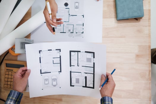 A team of engineers and architects discuss house plan design and estimate construction prices to suit the construction budget. Checking blueprints and documents with a team of engineers and architects photo
