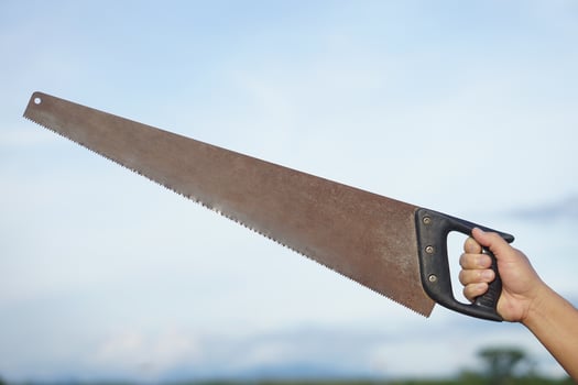 Close up carpenter hand holds old saw. Concept, tool for cutting. Carpentry , woodwork and construction work tool. Carpentry. use for cutting wood. Handsaw for carpenter. photo