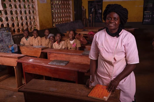 African female teacher in the foreground in the classroom during the lesson photo