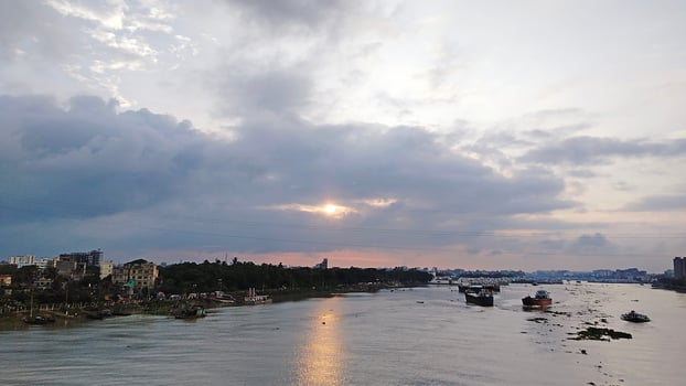 Beautiful scenery of colorful clouds reflecting in the river during sunset photo
