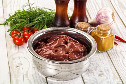 Raw chicken liver uncooked in the bowl photo