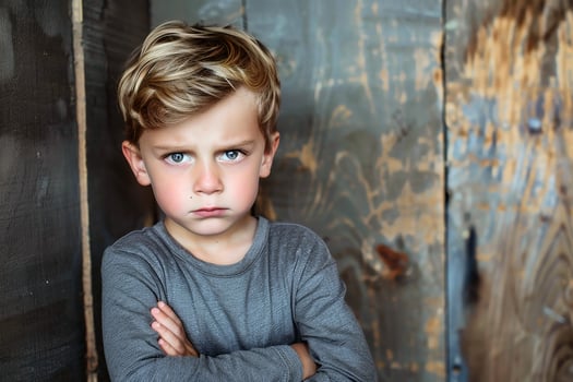 An offended little boy with his arms crossed. AI generate photo