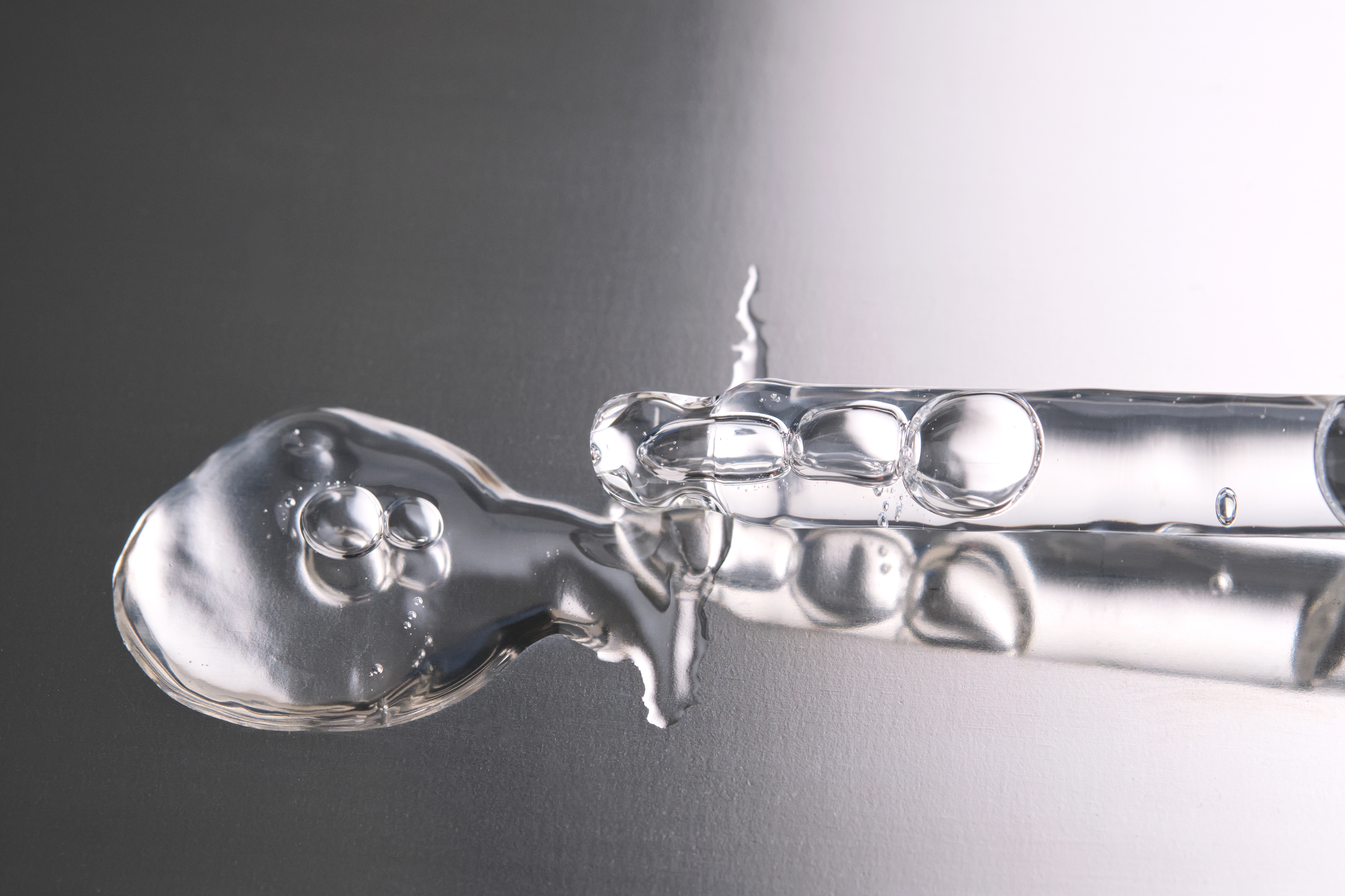 Pipette with cosmetic gel or serum close-up. photo