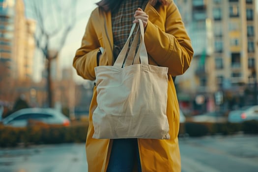 unrecognizable woman carrying reusable bag in hand. photo