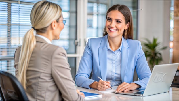 Two businesswomen working together in an office. Focus on the woman photo