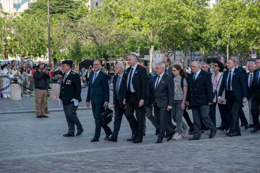 French war veterans wearing uniforms and representatives at a military ceremony under the Arc de Triomphe photo