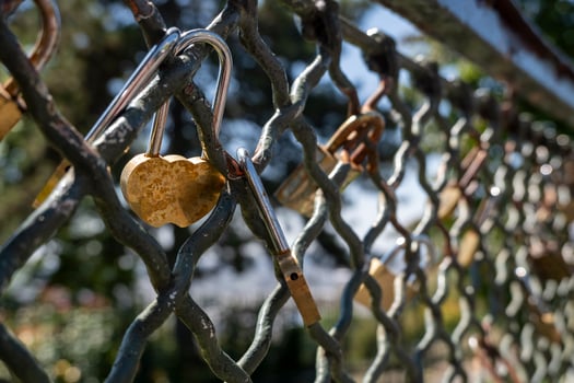 padlock stuck in metal fence photo