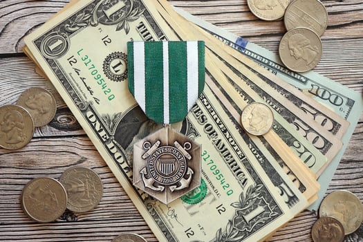 KYIV, UKRAINE - JULY 10, 2024 The Coast Guard Commendation medal. United States military award medal with ribbon and pin. Handmade paper theater props photo