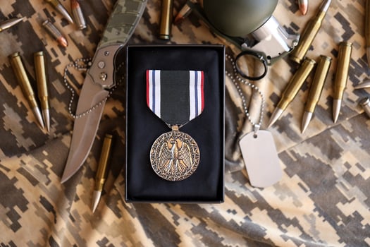 KYIV, UKRAINE - JULY 10, 2024 Prisoner Of War medal. United States military award medal with ribbon and pin. Handmade paper theater props photo