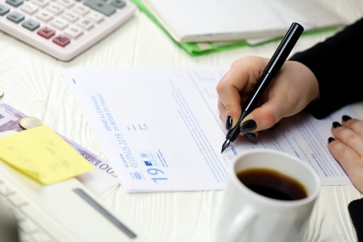 KYIV, UKRAINE - OCTOBER 31, 2023 Accountant fill french tax form 2042 NR departure abroad or return to France in end of tax period. Taxation and paperwork routine photo