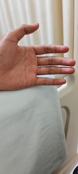 Portrait of a man hand lying in a hospital patient's room photo