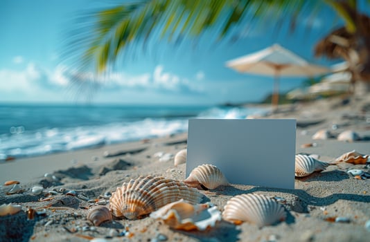Blank card on a sandy beach with seashells, palm leaves, and ocean, perfect for tropical designs photo