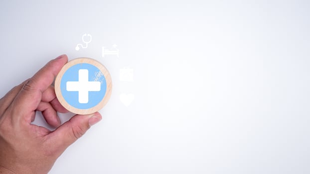 Human hand holding a plus sign and healthcare medical icon on white background, Health insurance concept, Health and access to welfare health concept, Welfare service concept, Healthy and lifestyle. photo