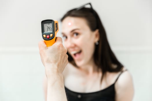 Checking Body Temperature with Infrared Thermometer photo